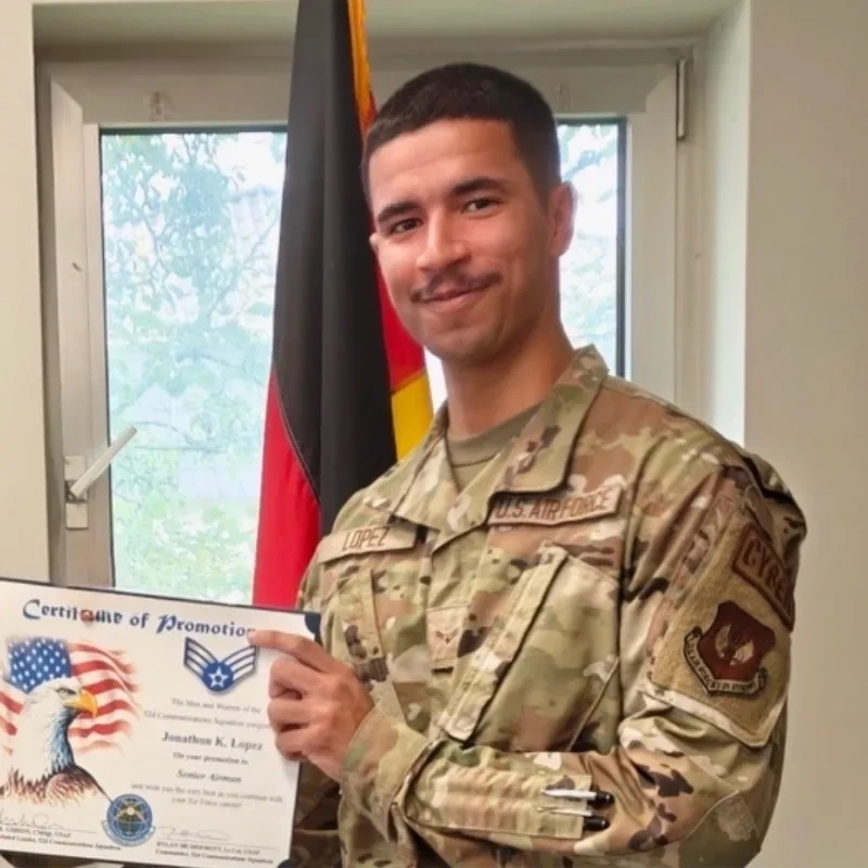 Jonathon “Joni” Kristofer Lopez in his U.S. Air Force uniform, holding his promotion certificate.